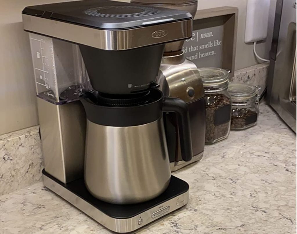 OXO Coffee Maker on counter next to canisters