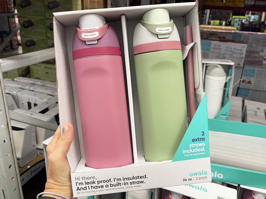 hand holding a set of pink and green owala water bottles