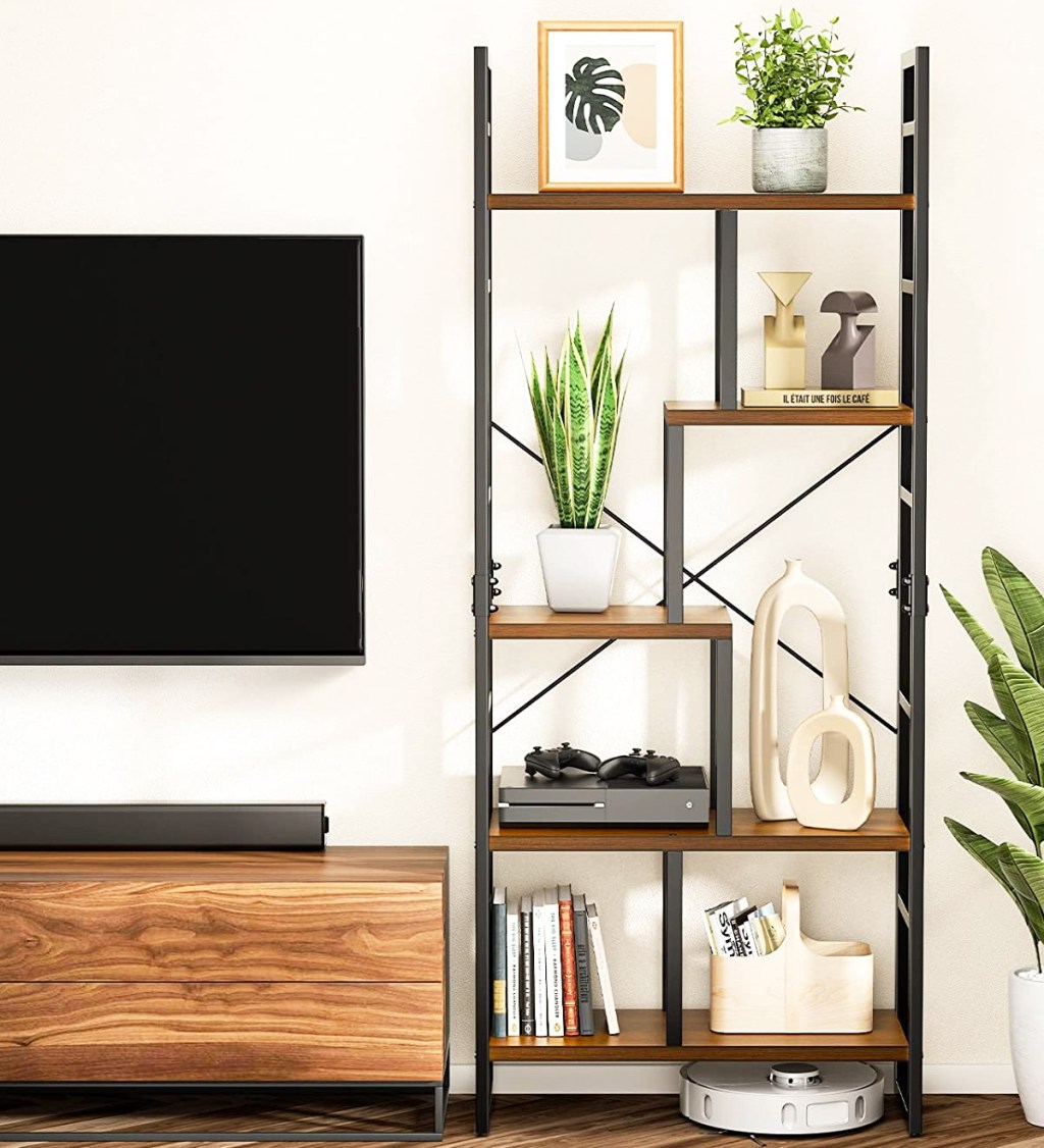 5-tier bookshelf with staggered shelves with plants and decor on each shelf