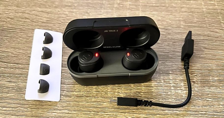 Skulcandy Jib Earbuds with the charging case, extra ear tips and a charging cable