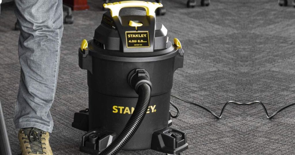 man using a stanley wet dry vac