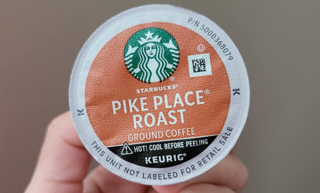 Starbucks Pike Place Roast K-Cup Coffee Pod in ewomans hands 