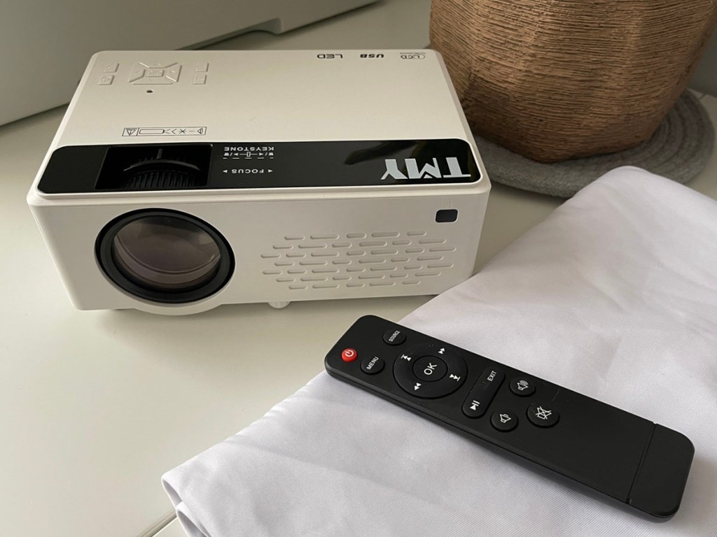 white tmy projector with remote