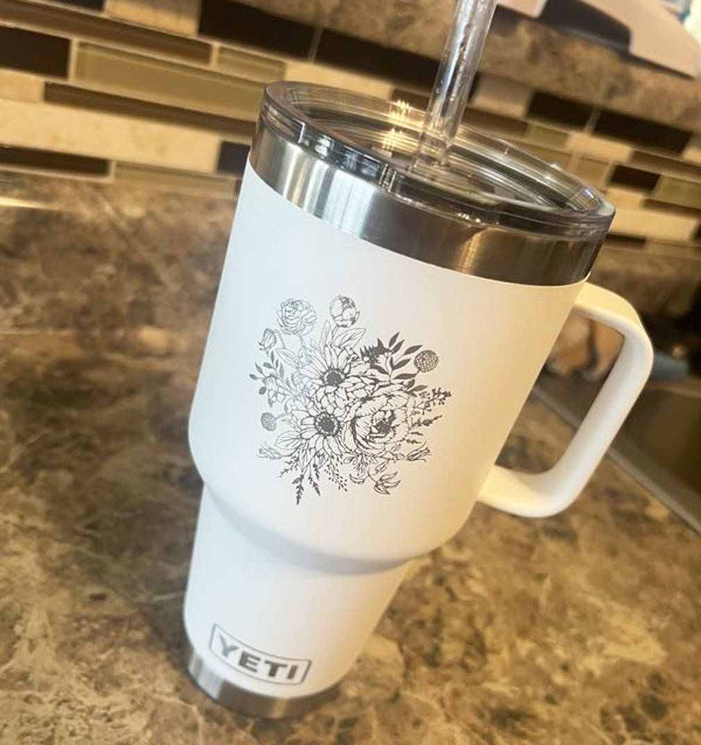 white yeti mug with engraved flower design