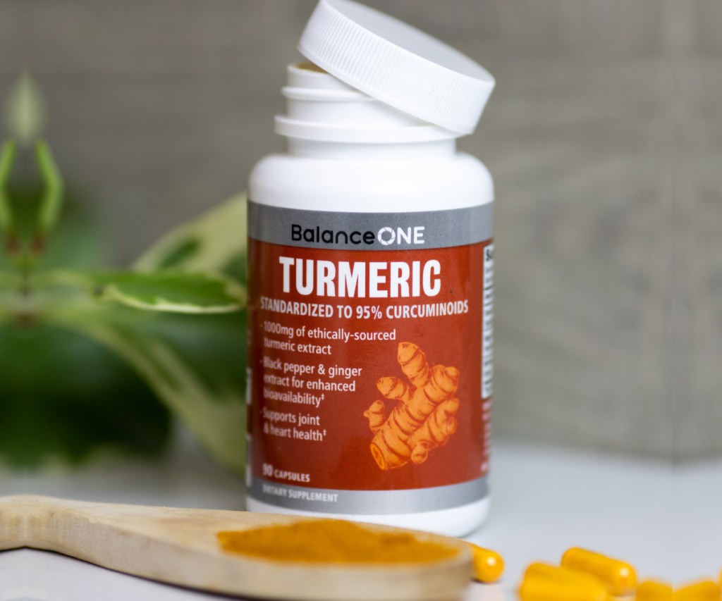 bottle of turmeric vitamins with lid coming off