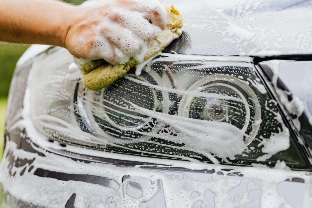 hand holding large sponge washing car - fathers day gift ideas