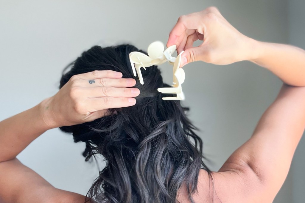 woman putting hair clip in hair