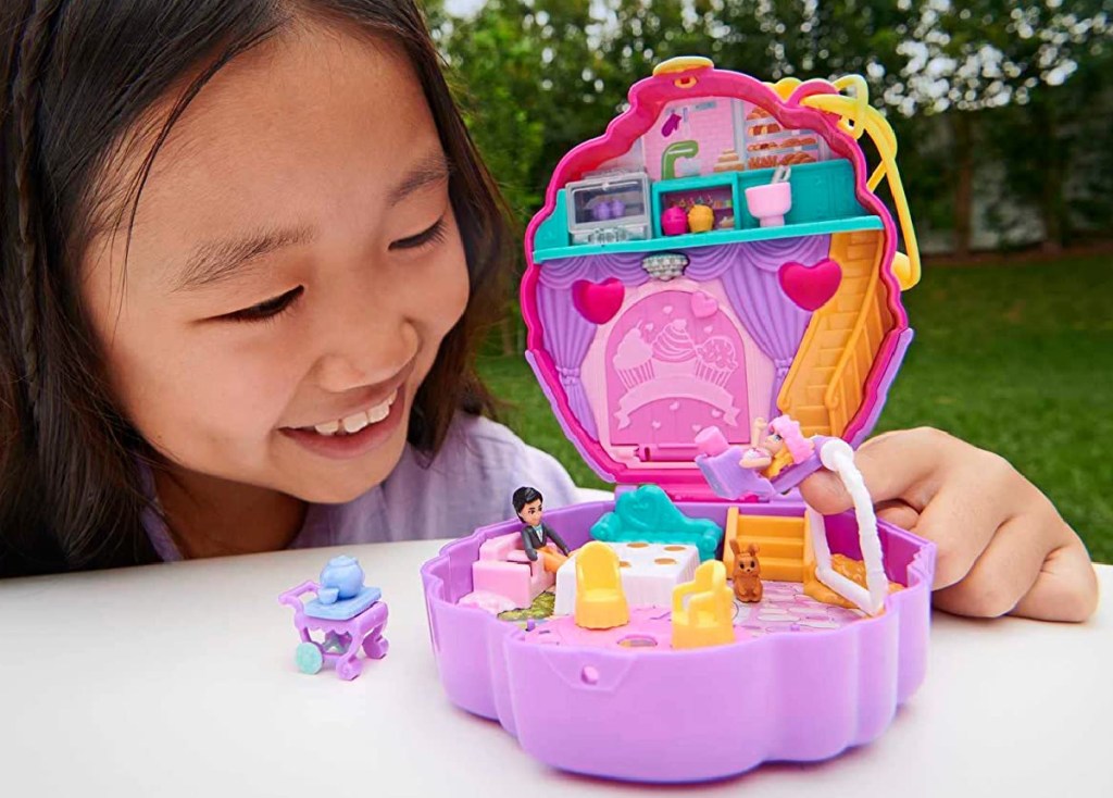 girl playing with Polly Pocket Something Sweet Cupcake Compact Playset