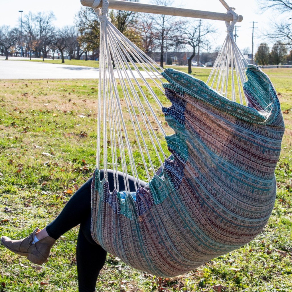 person sitting in hammock chair