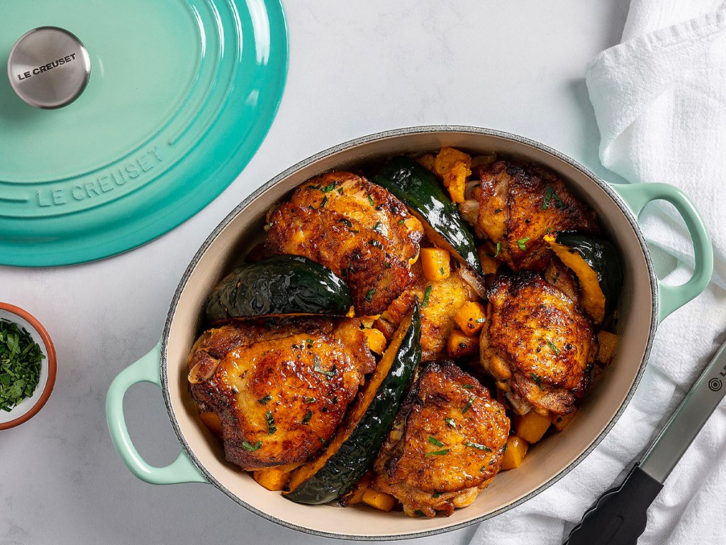 green le creuset dutch oven with chicken inside