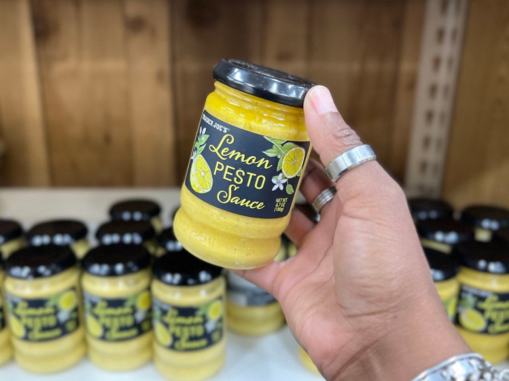 hand holding lemon pesto sauce in trader joes