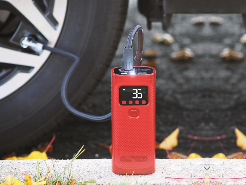 red mini air compressor connected to tire