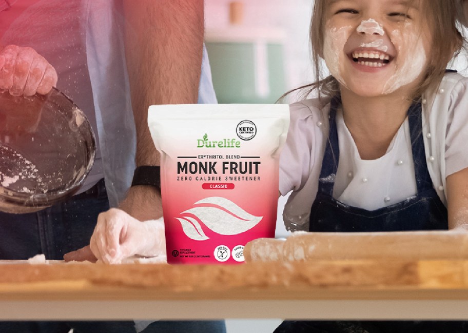 little girl baking with a bag of monk fruit sweetener in front of her