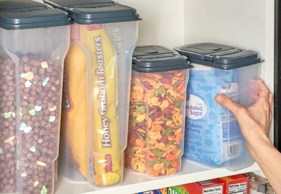 4 pc clear food storage set with black flip pour seals on pantry shelf with food in them