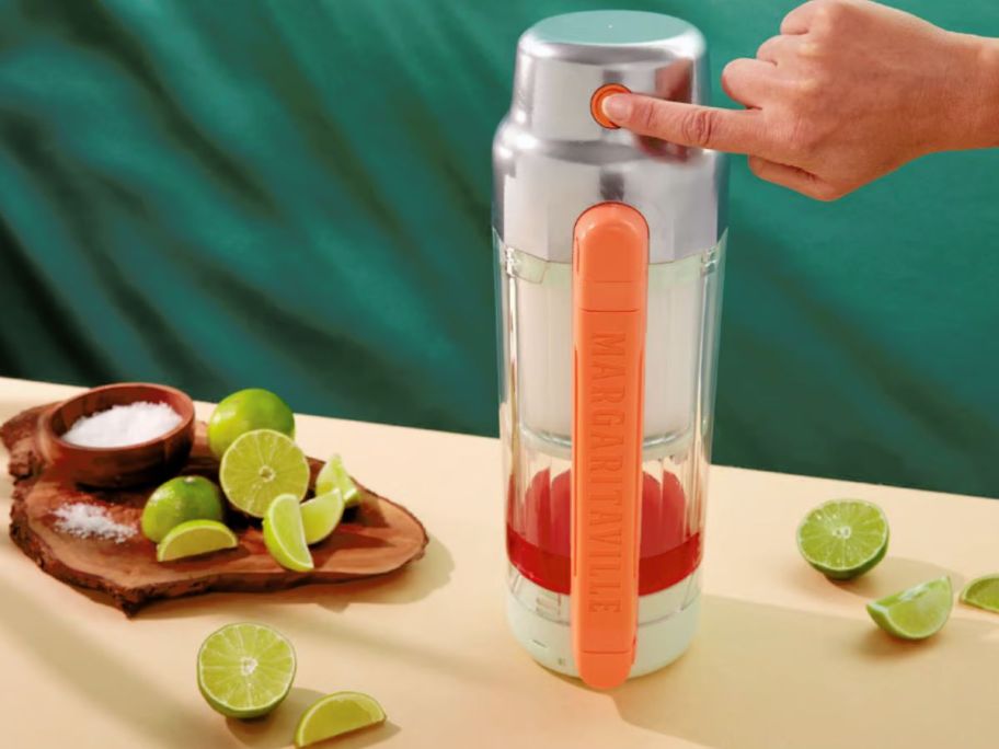 finger pushing the button a Margaritaville Maui portable blender