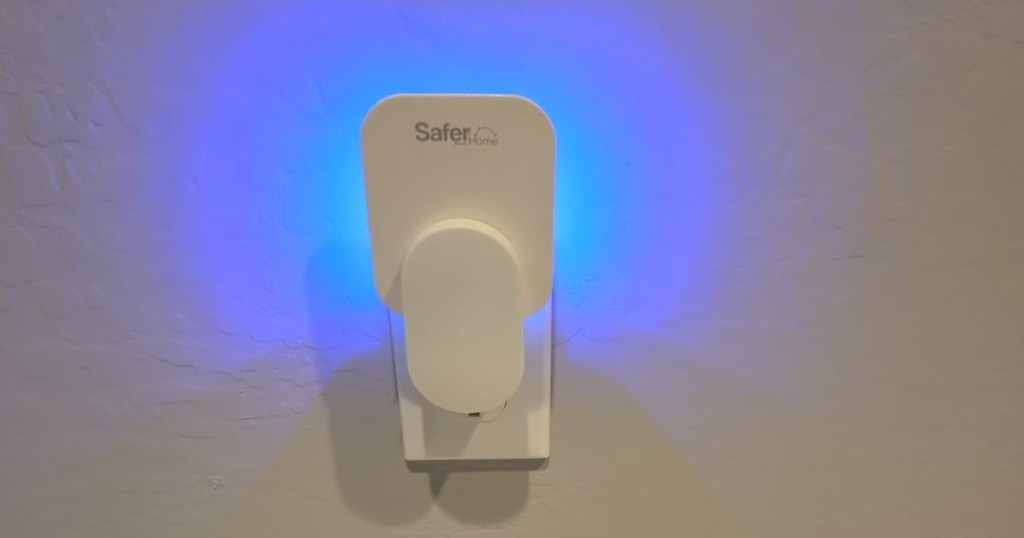 glowing blue fly trap plugged into wall