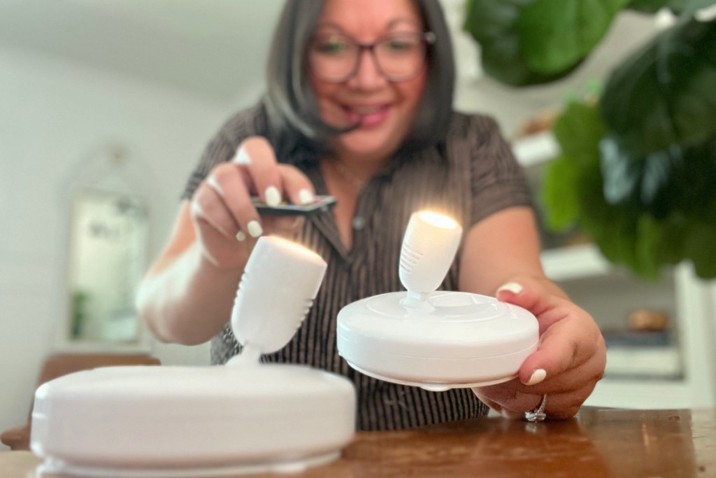 woman using a remote on a LED tree lamp