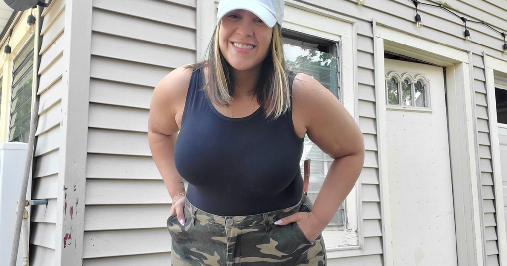 woman wearing black bodysuit with camo pants