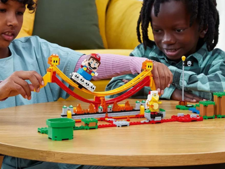 Boy and Girl playing with LEGO Super Mario Lava Wave Ride Expansion Set