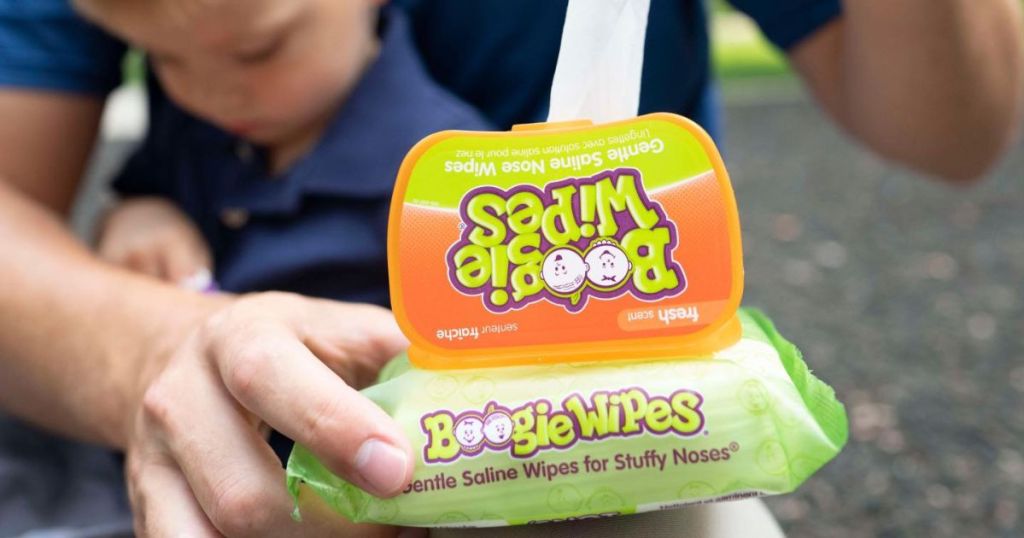 Man pulling a Boogie Wipes to use on a baby, also shown