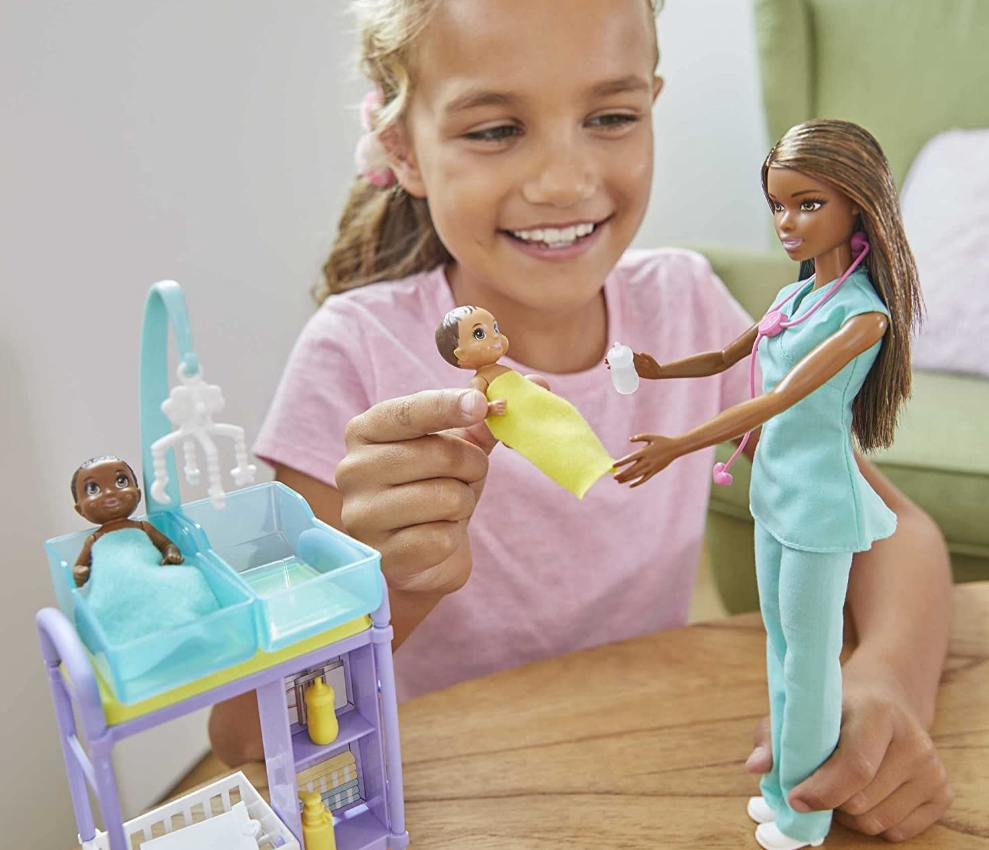 Girl playing with a Barbie doctor playset