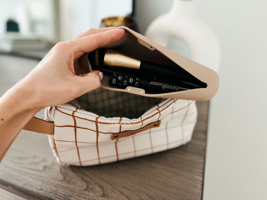 Hand holding a brush holder