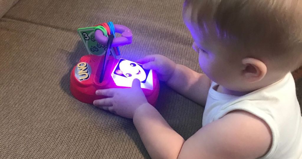 Little Boy playing with a Fisher Price UNO Toy