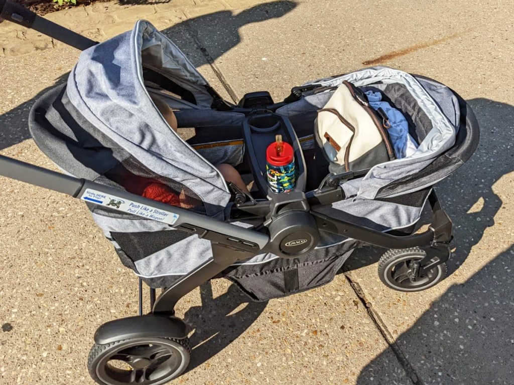 large grey and black wagon with child inside