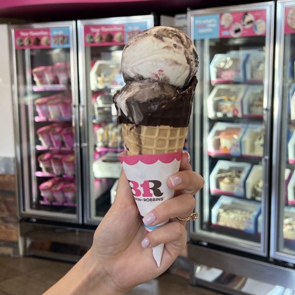 Baskin Robbin's Ice Cream Scoops in a cone in woman's hand