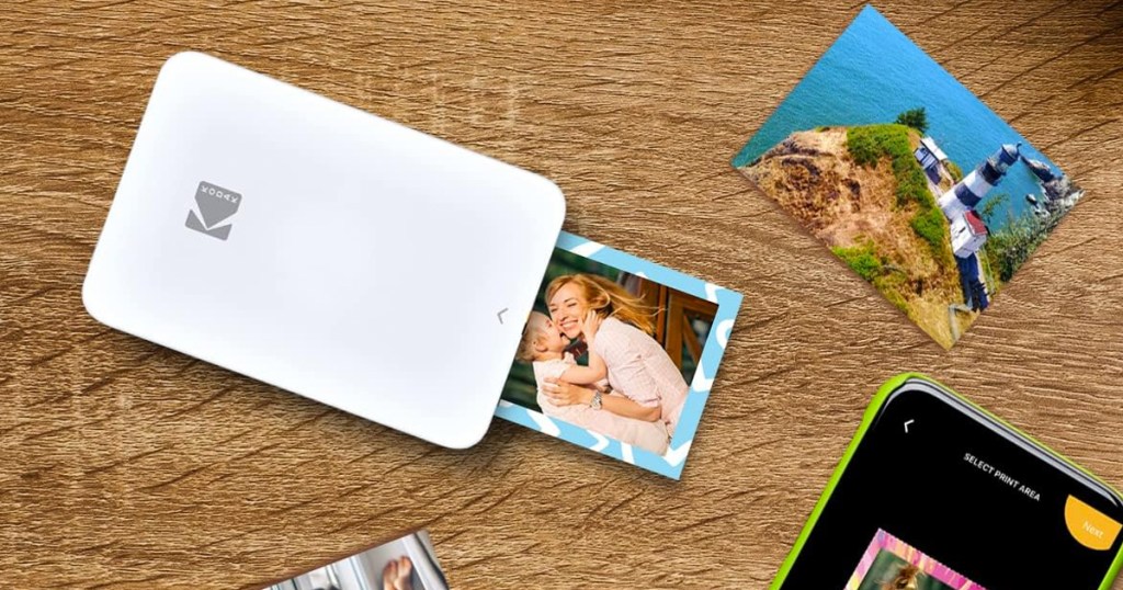 small white photo printer printing out photos on wood table