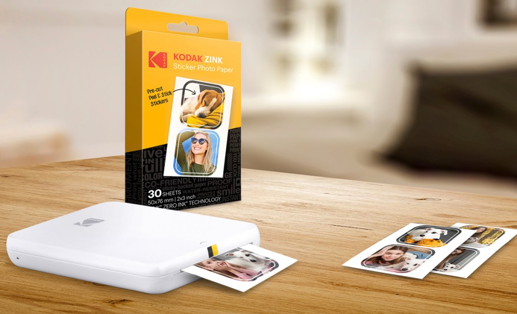 kodak mini photo printer next to box of photo paper and photo stickers