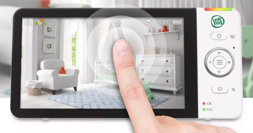 a person's finger on the touchscreen of a LeapFrog Remote Access 1080p Touch Screen baby monitor