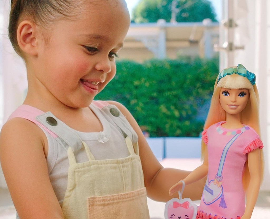 Girl holding a Barbie doll