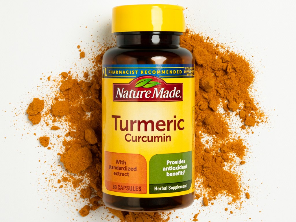 bottle of Nature Made Turmeric on top of turmeric powder