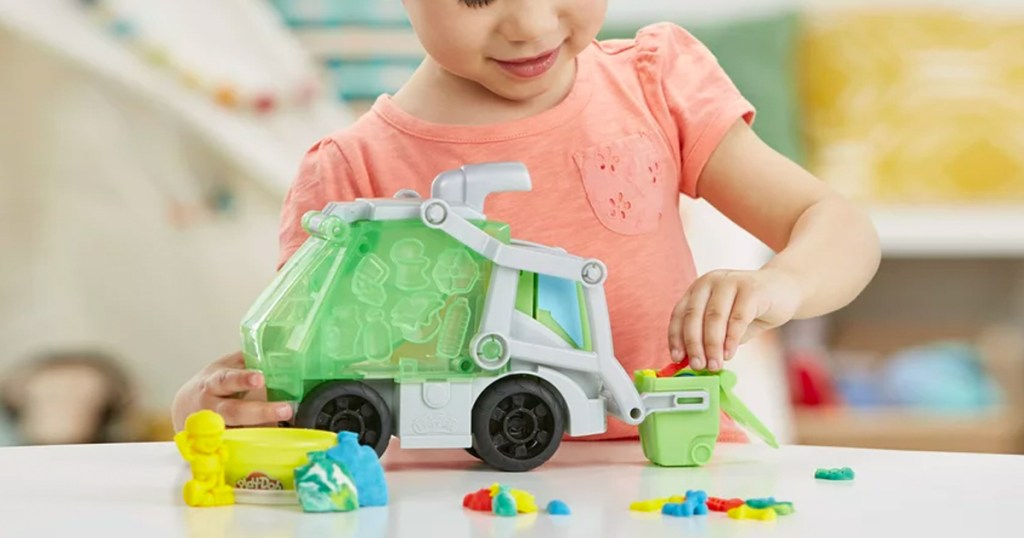 child playing with a Play-Doh Wheels Dumpin' Fun 2-in-1 Garbage Truck