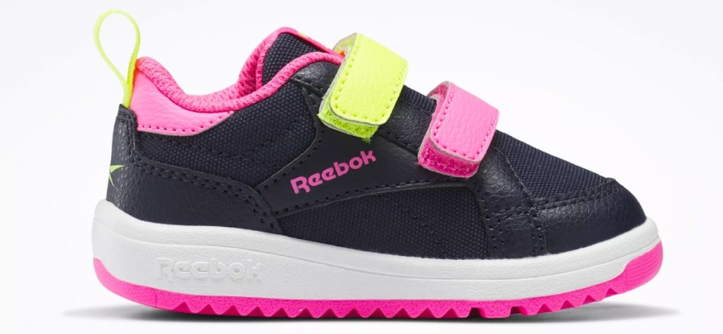 black, pink, and yellow reebok toddler shoe