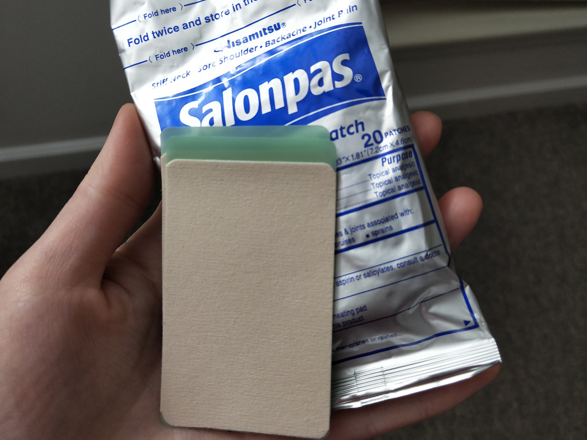 person holding Salonpas Pain Patches