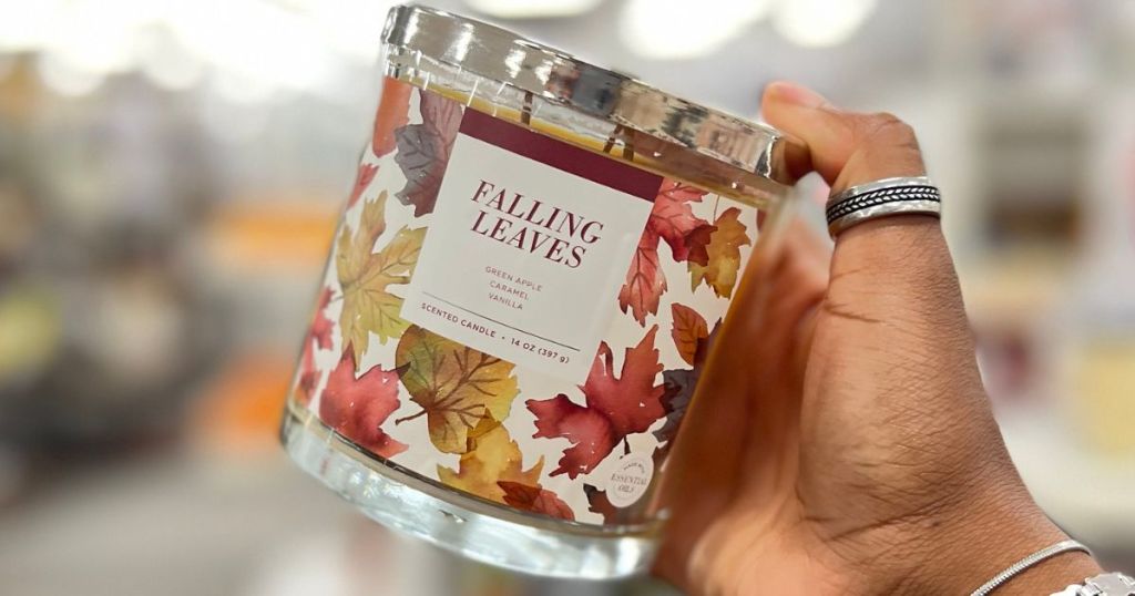 Hand holding up a Sonoma Goods for Life Falling Leaves Candle