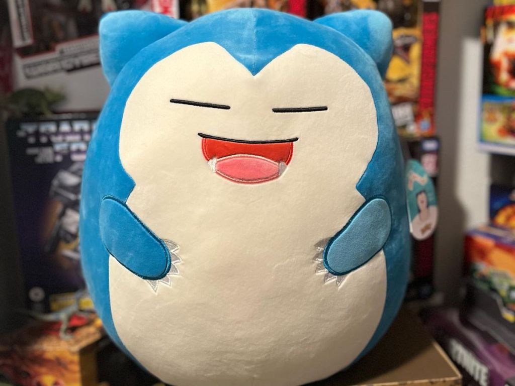 Squishmallow Snorlax sitting on a box