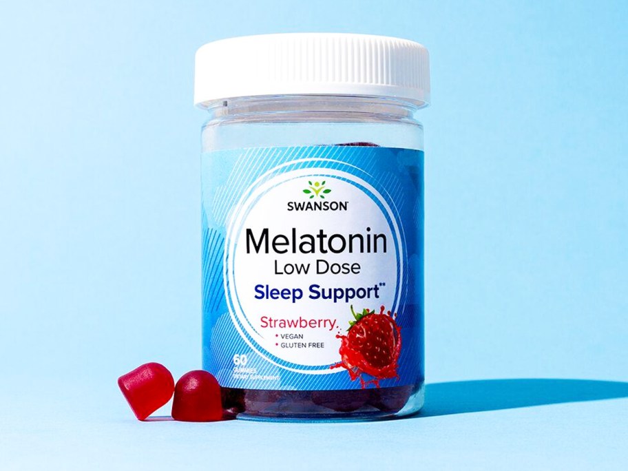 bottle of Swanson Premium Melatonin Low Dose Gummies with blue background