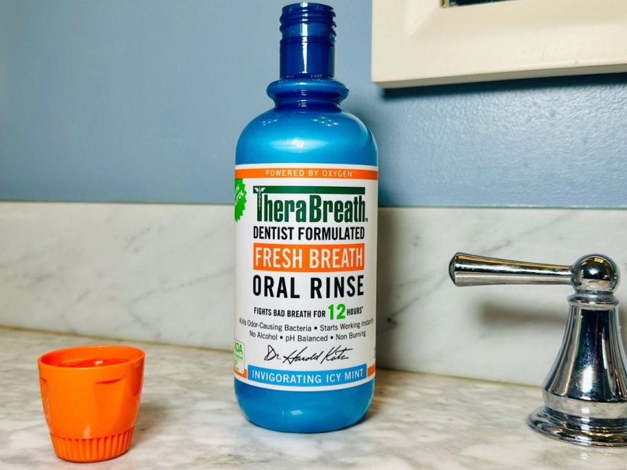 A bottle of Therabreath Oral Rinse on a counter