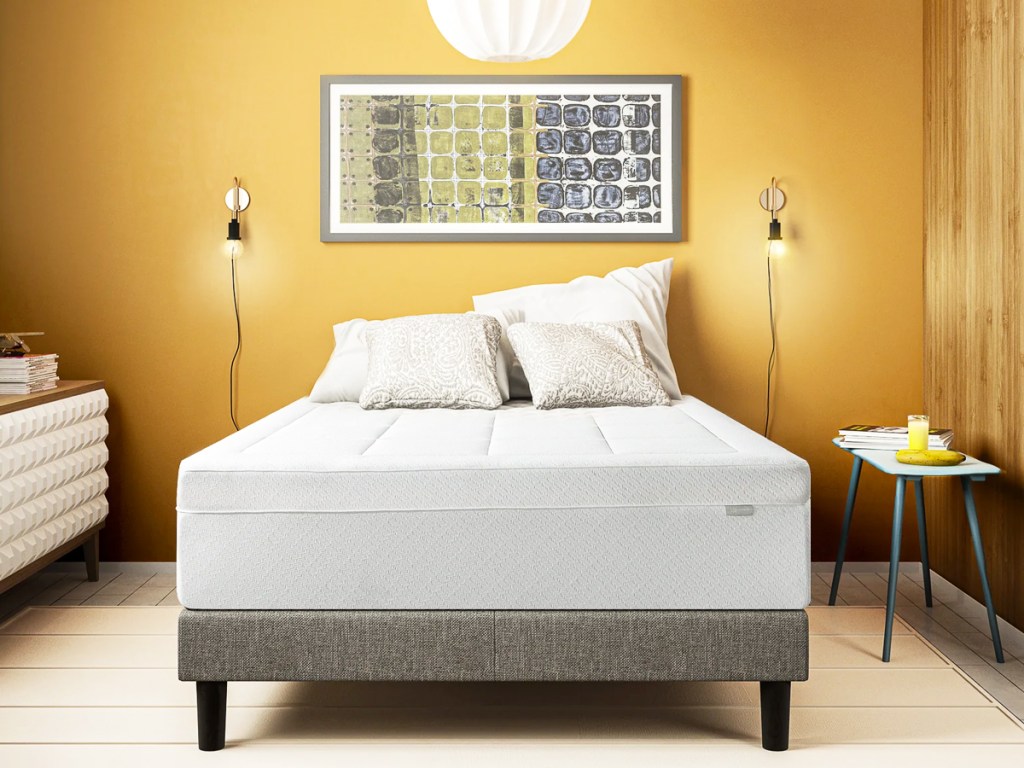 white mattress on a grey bed frame with pillows on top