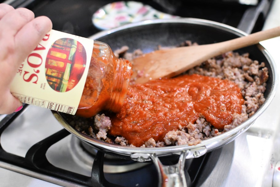 adding rao's marinara to sausage in a skillet