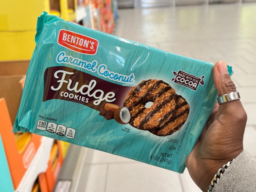 holding a package of fudge stripe cookies