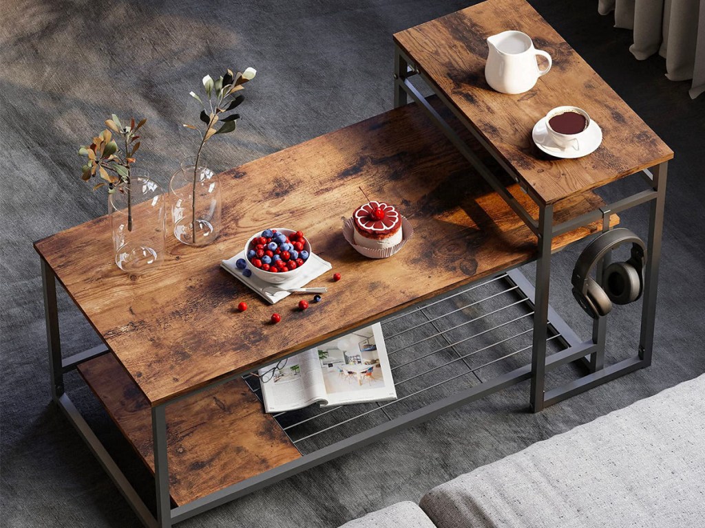 brown coffee table with wine and food sitting on it