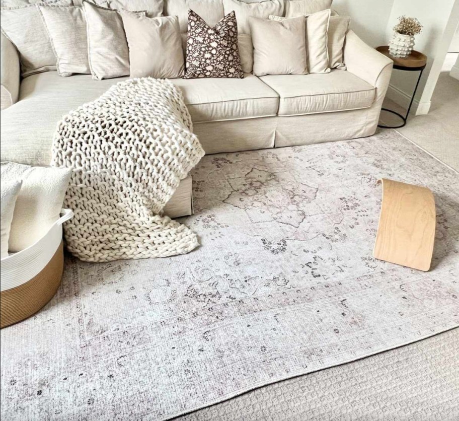 light grey washable rug on floor under couch