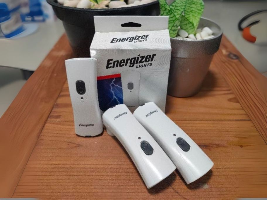 three energizer flashlights on table in front of box