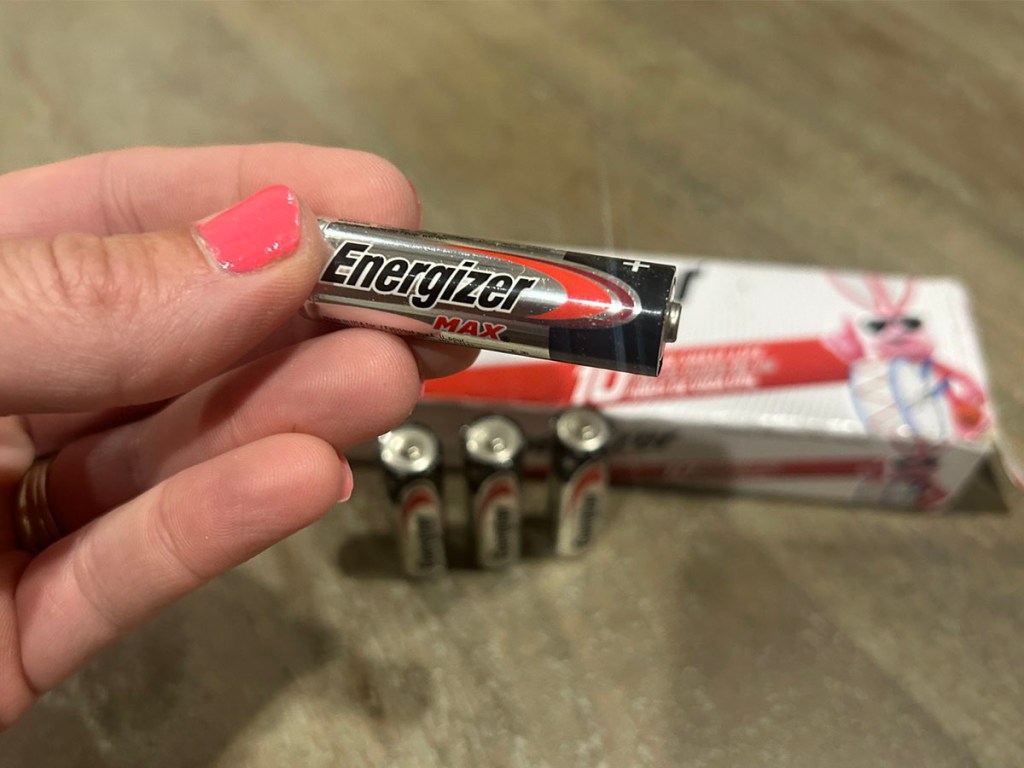hand holding aa energizer battery