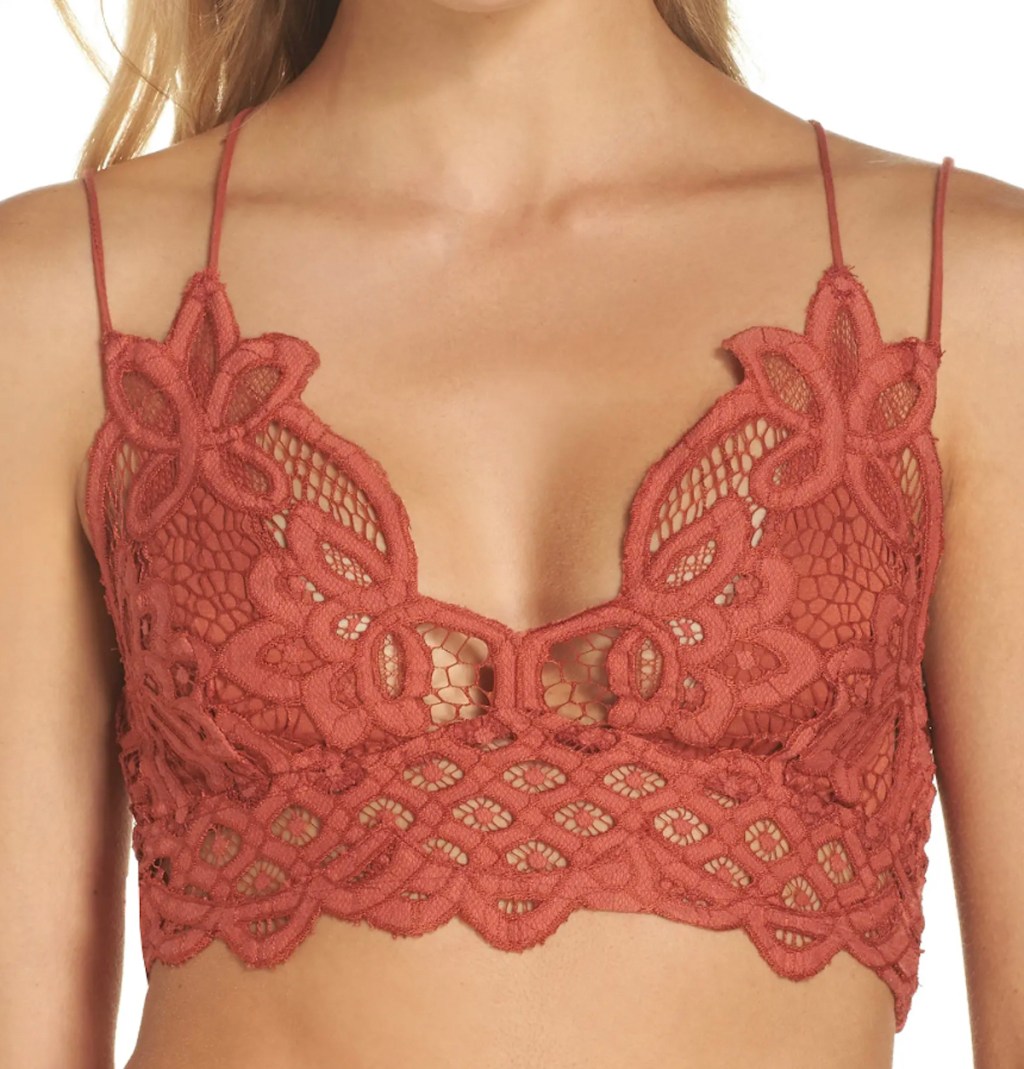 stock photo of woman wearing burnt orange lace bralette