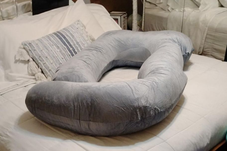 a full body pillow on a bed